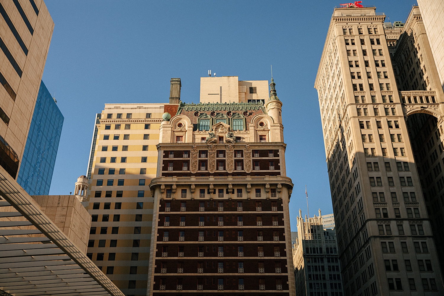 Adolphus hotel high rise exterior against blue sky