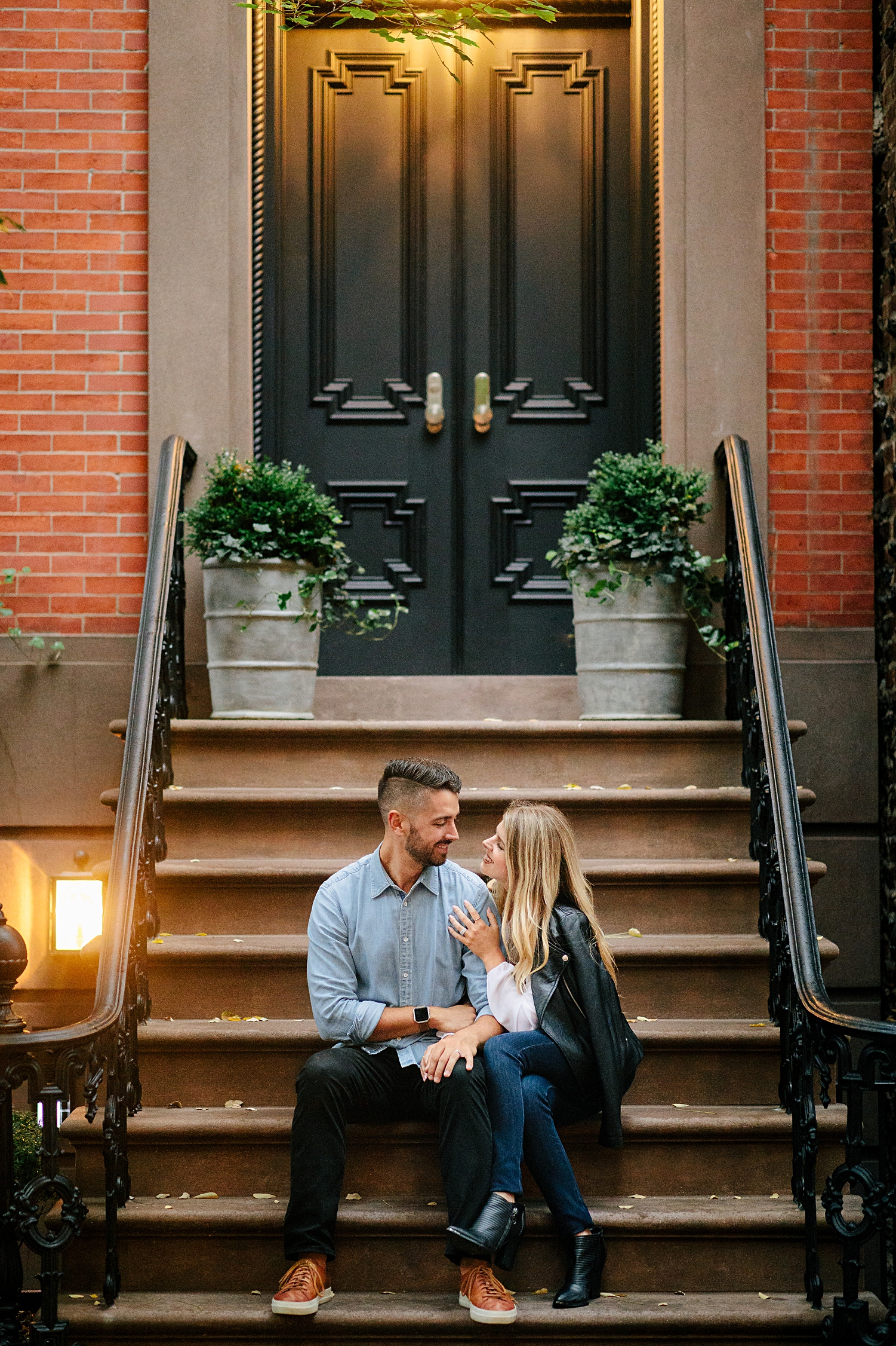 couple sitting on brownstone stoop in greenwich village engagement
