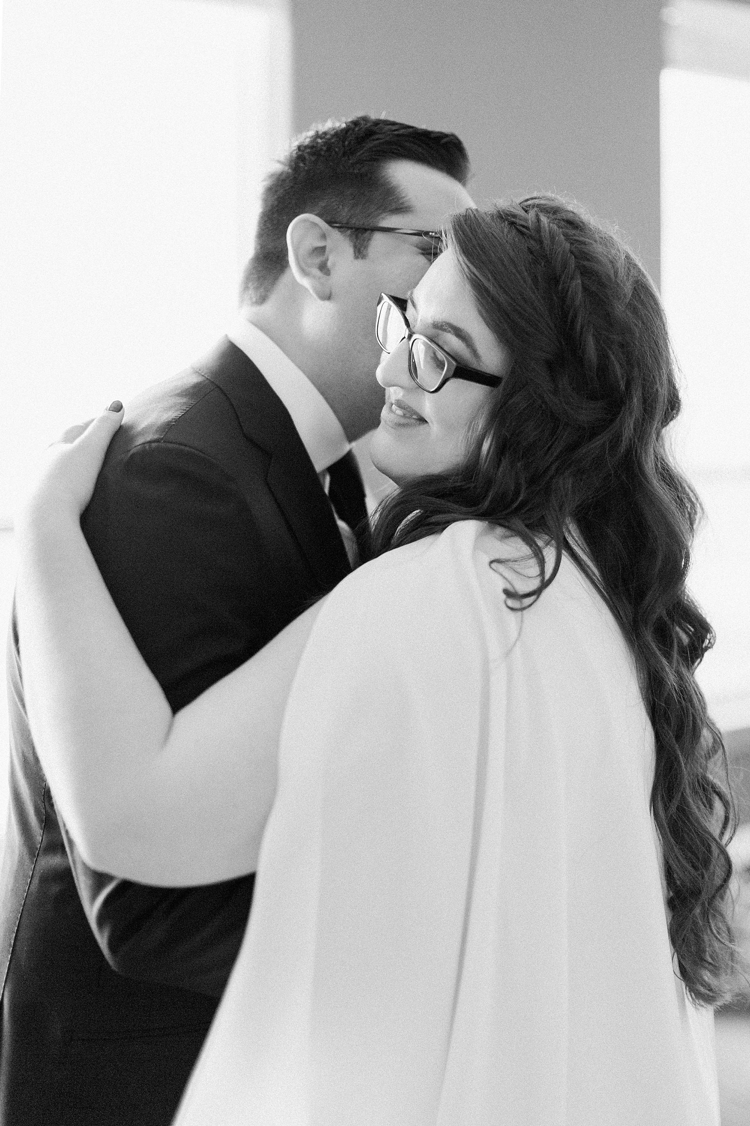 bride and groom hugging black and white