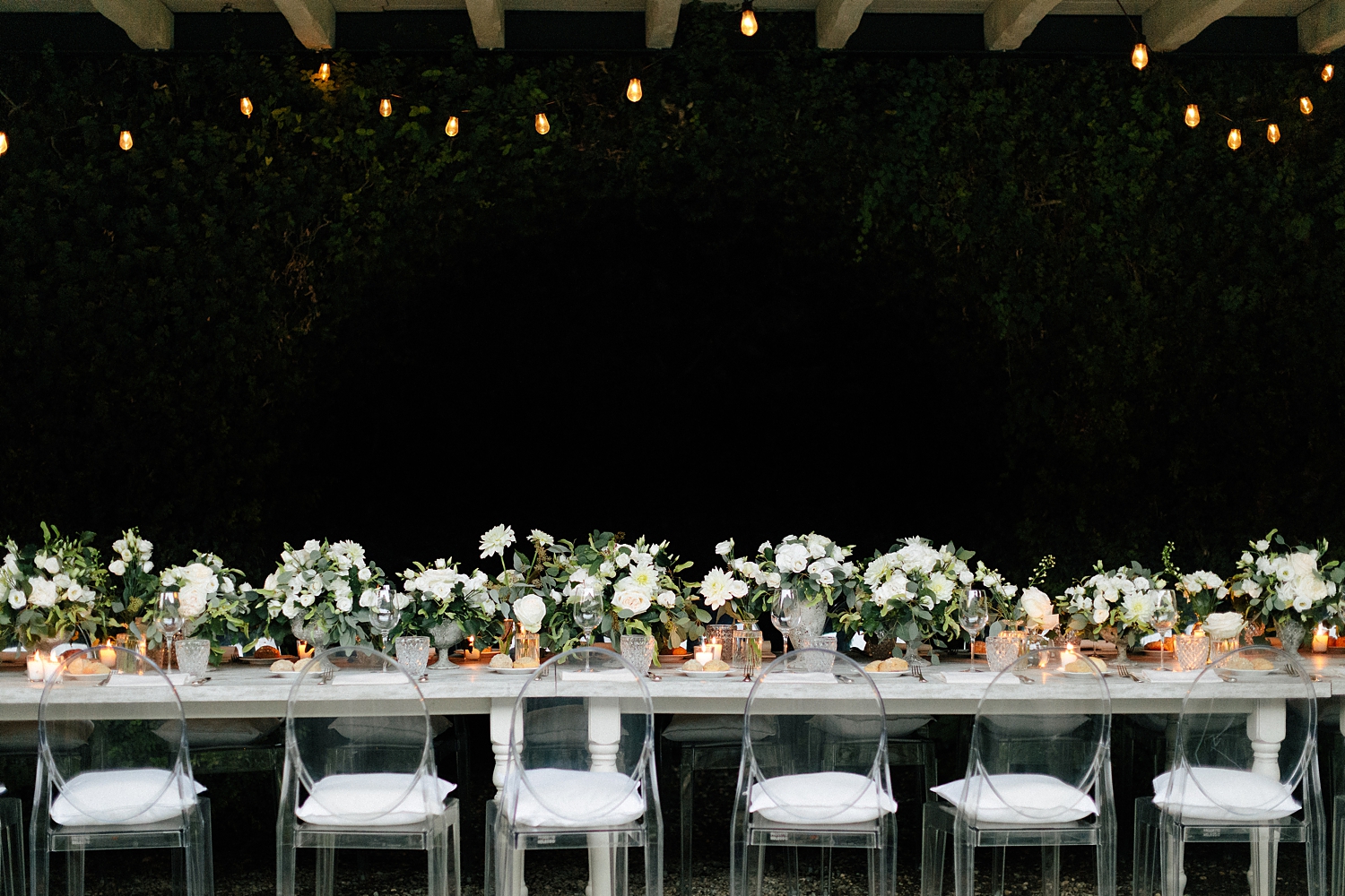 Italian Wedding Reception white florals long table under covered roof