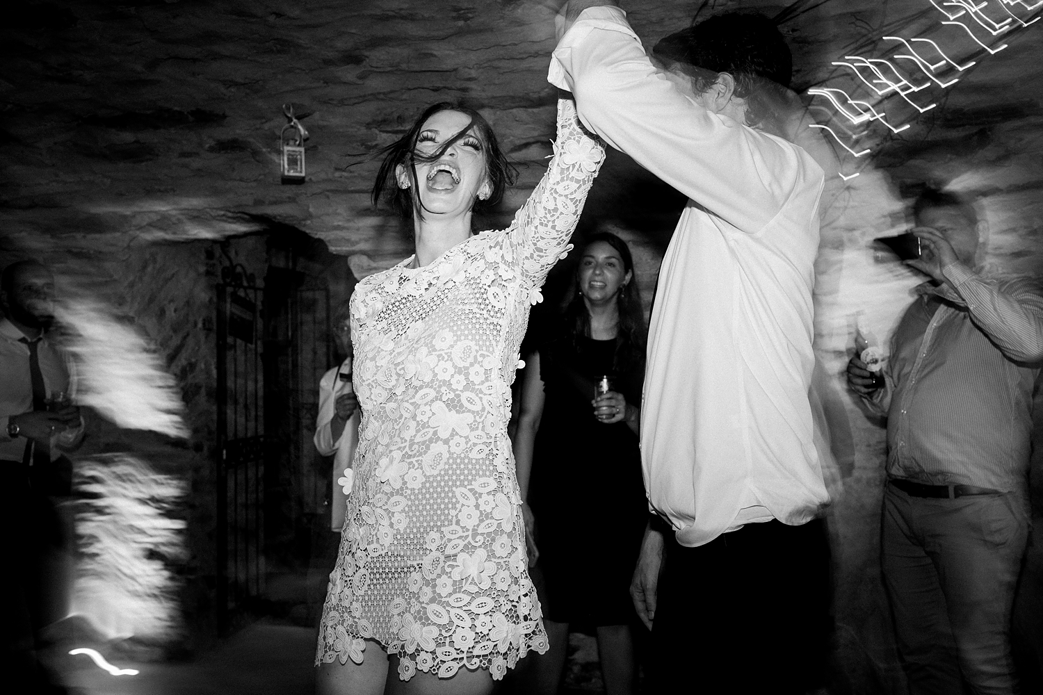 bride in lace reception dress dancing spinning laughing black and white Italy
