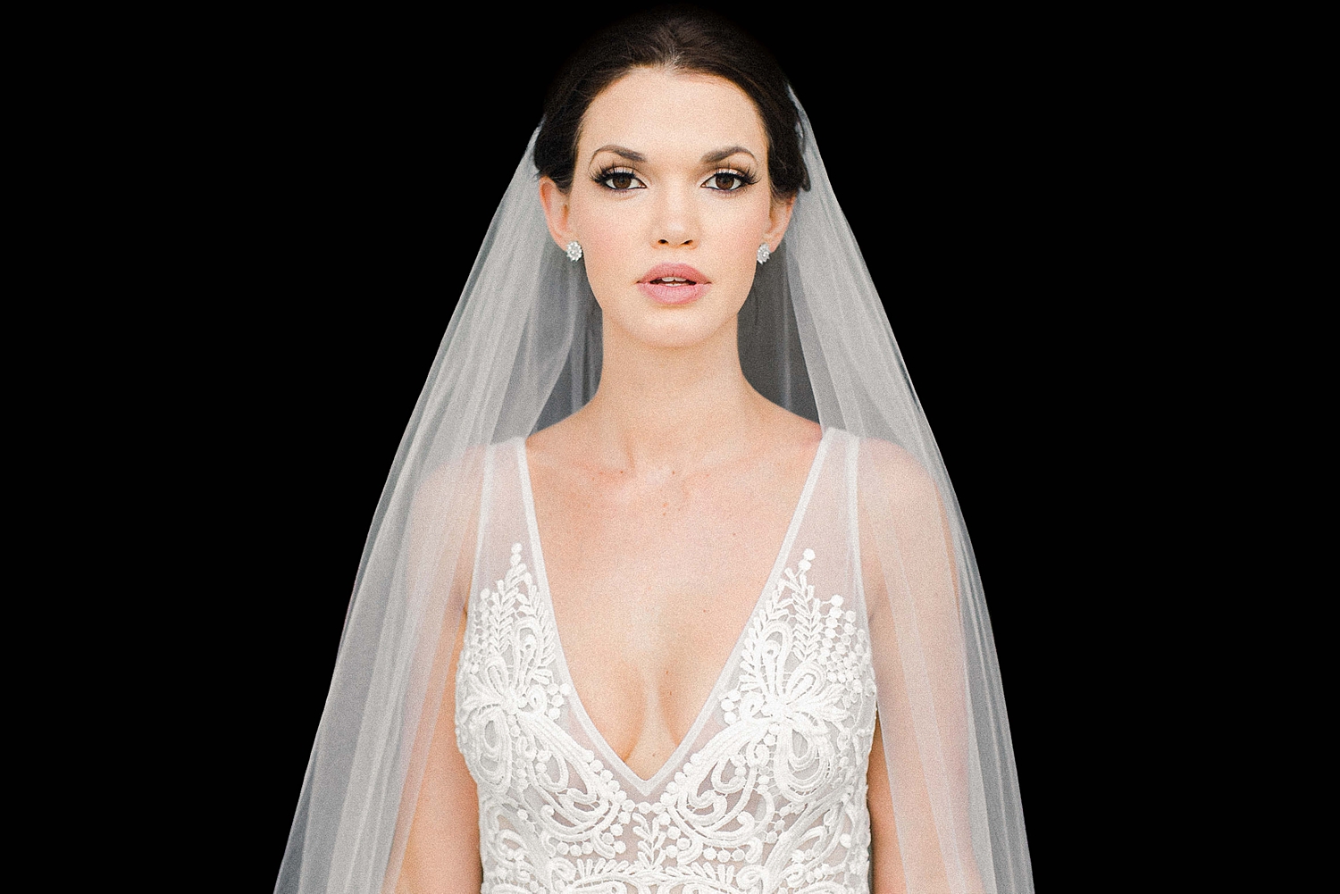 Bride in white lace wedding dress against black background at Lake Como Wedding
