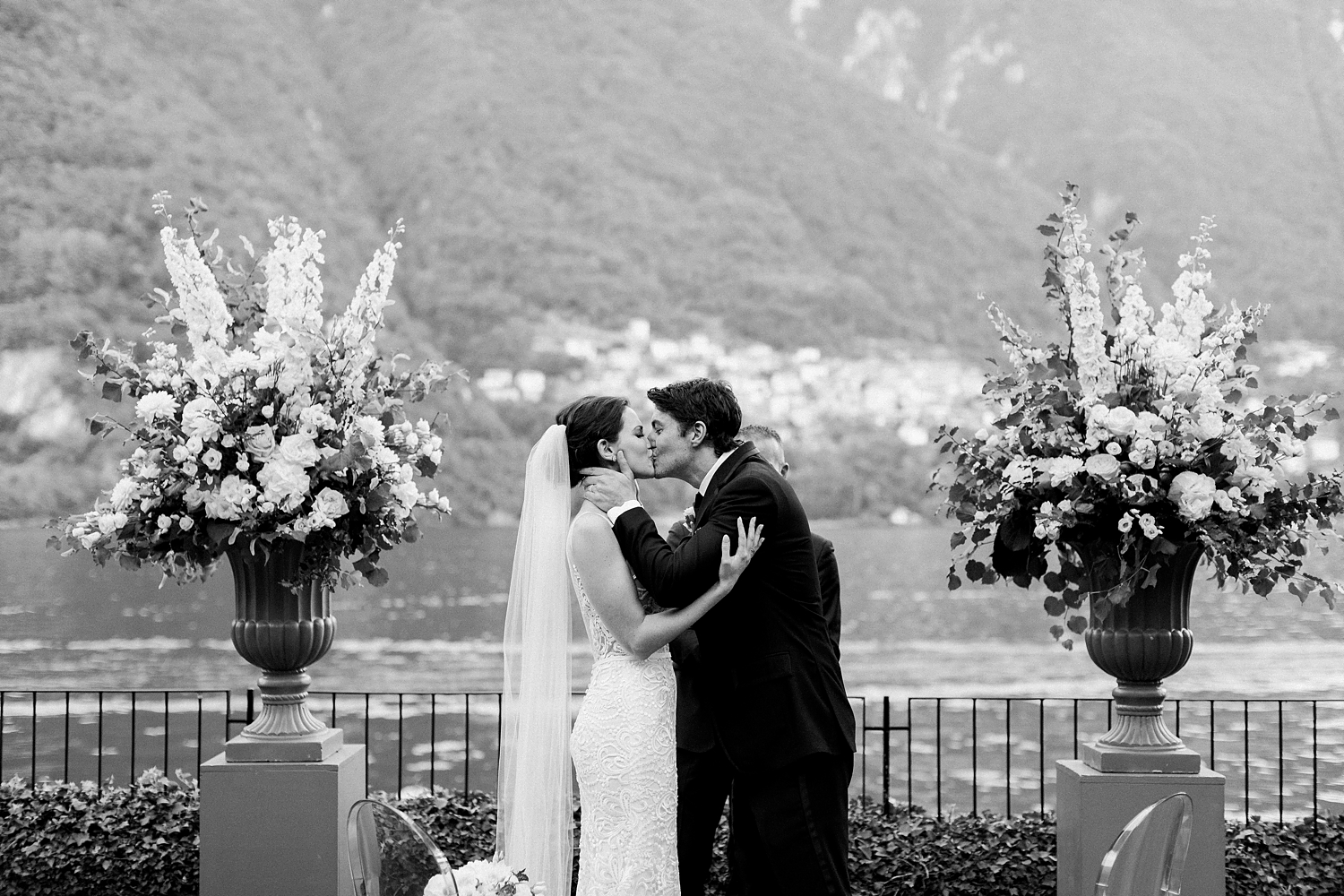 bride and groom first kiss at ceremony at Lake Como Wedding black and white