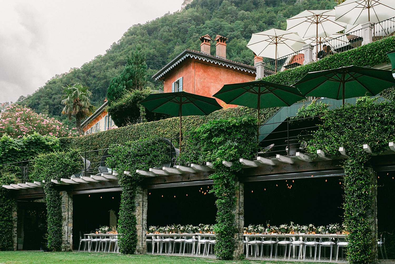 Lake Como Wedding Reception white florals long table under roof