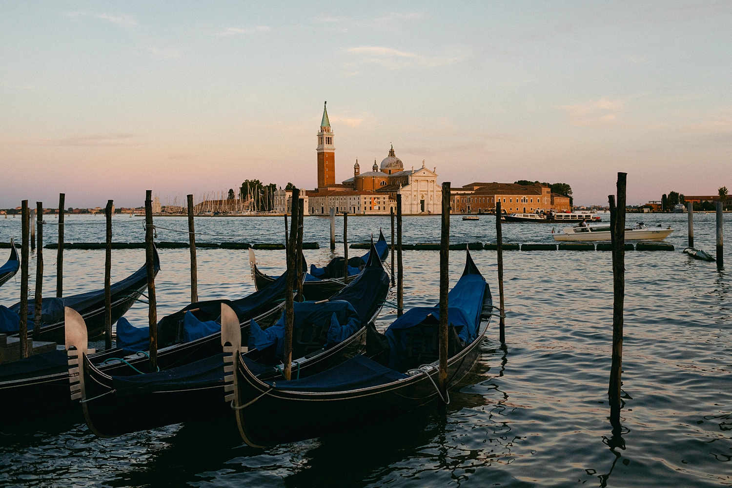 blue gondolas in Venice Grande Canal at sunset Italy