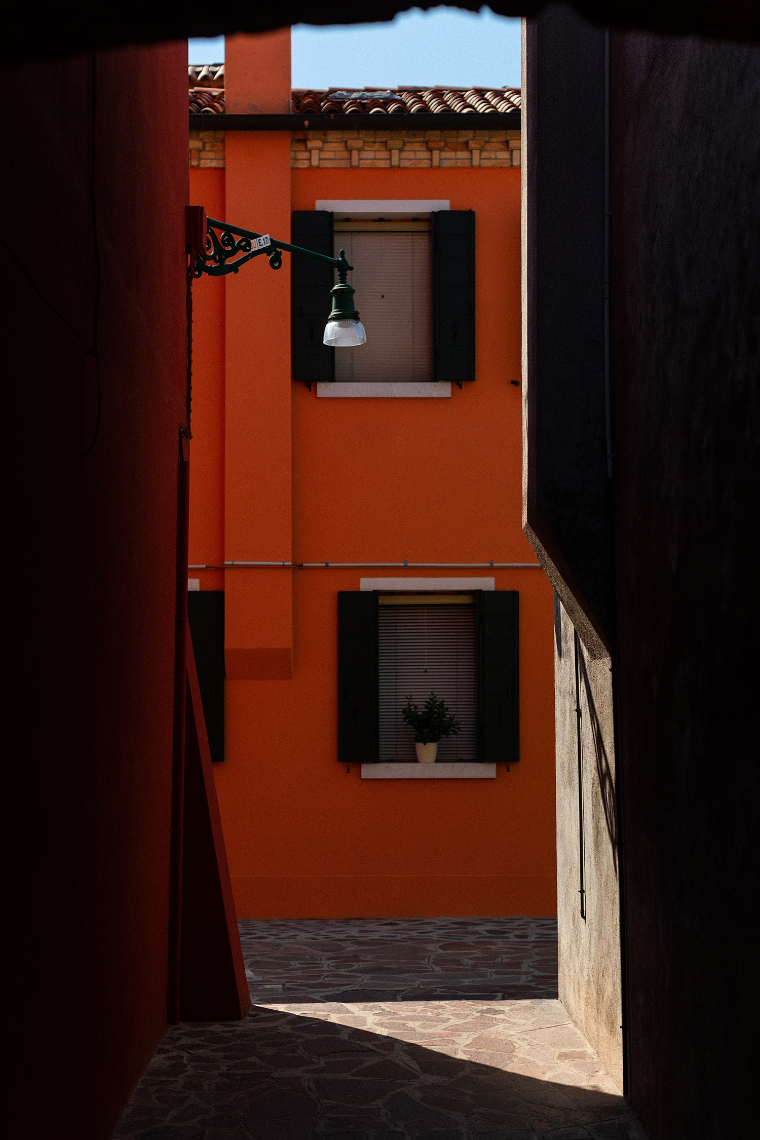 Burano Italy Street Scene red building shadows
