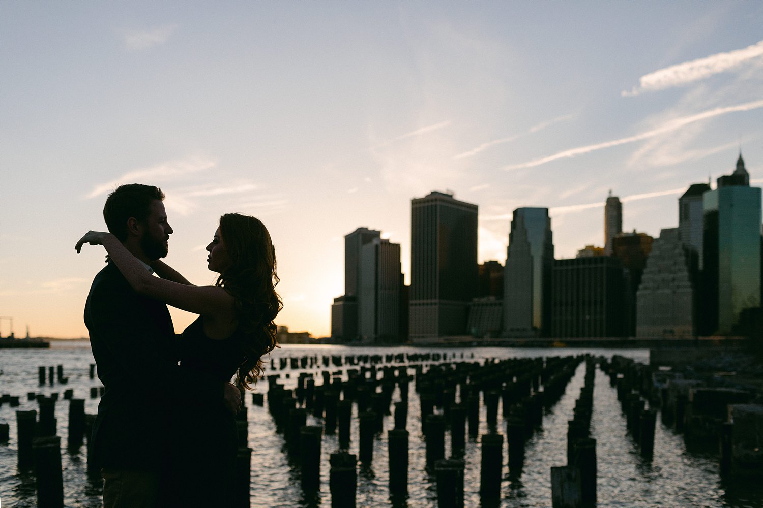 Downtown Manhattan Skyline from Brooklyn pier couple engagement session at sunset