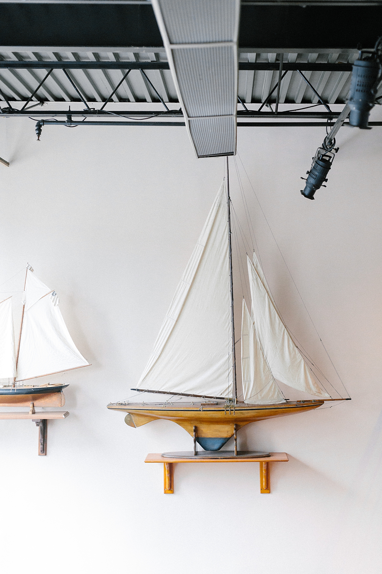 sailing ship models mounted on white wall