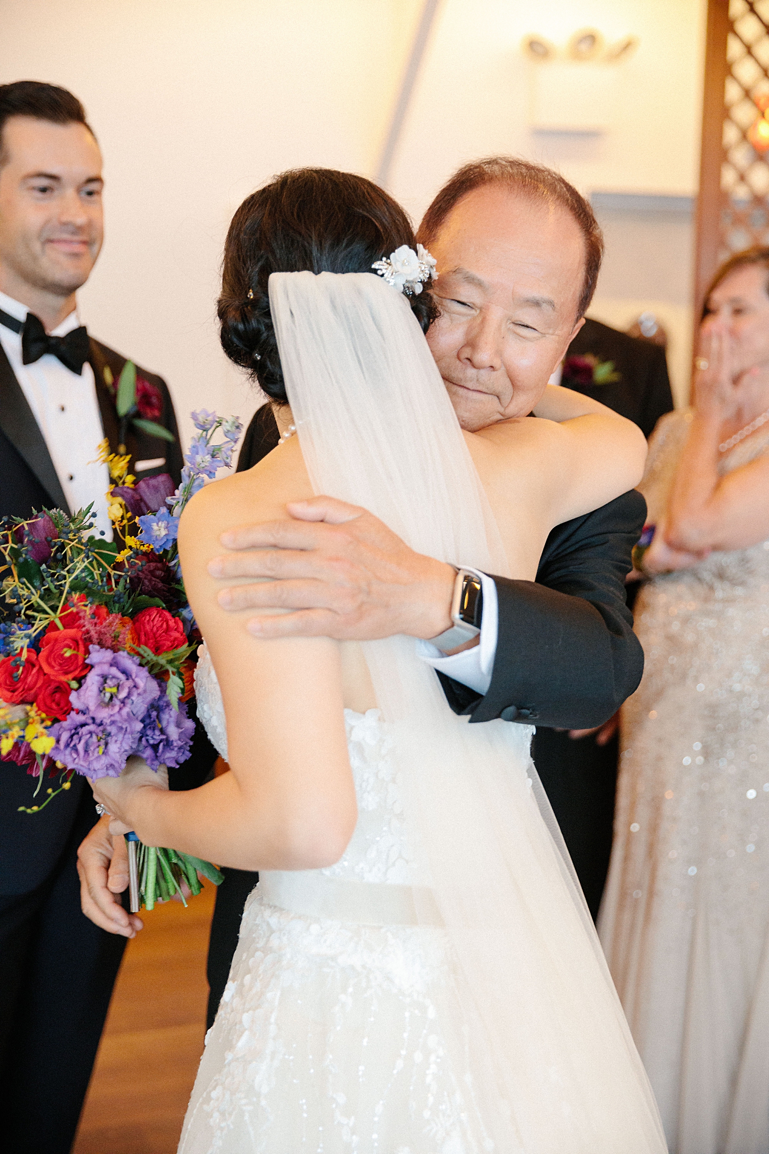 father hugging bride at wedding altar
