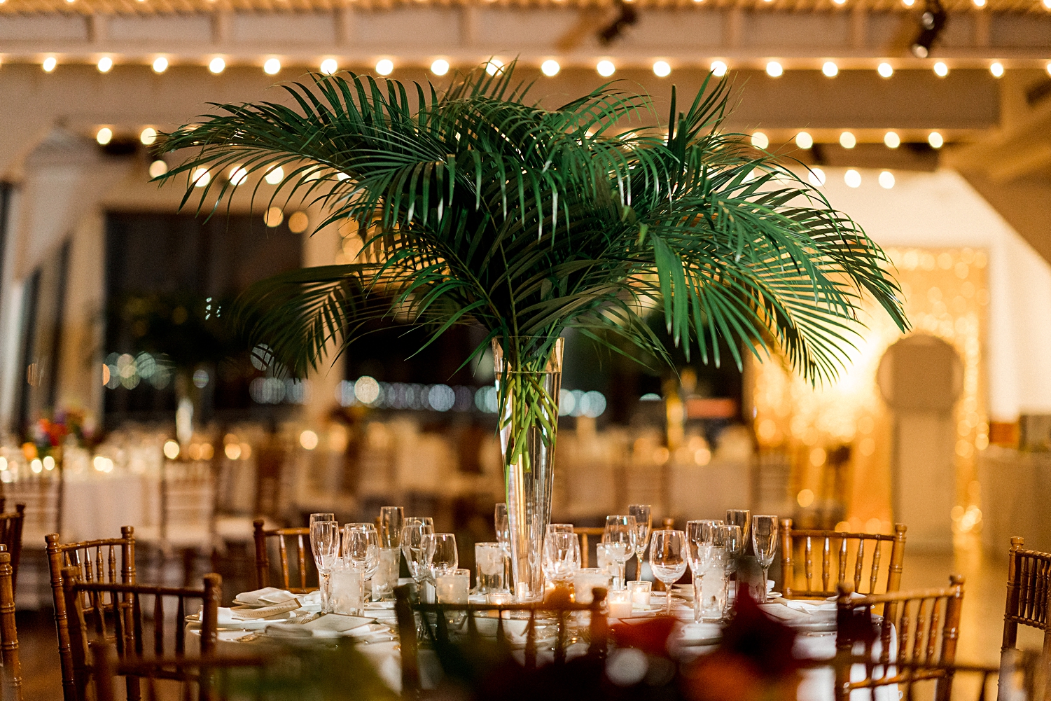 Wedding reception table decor with green fern centerpiece