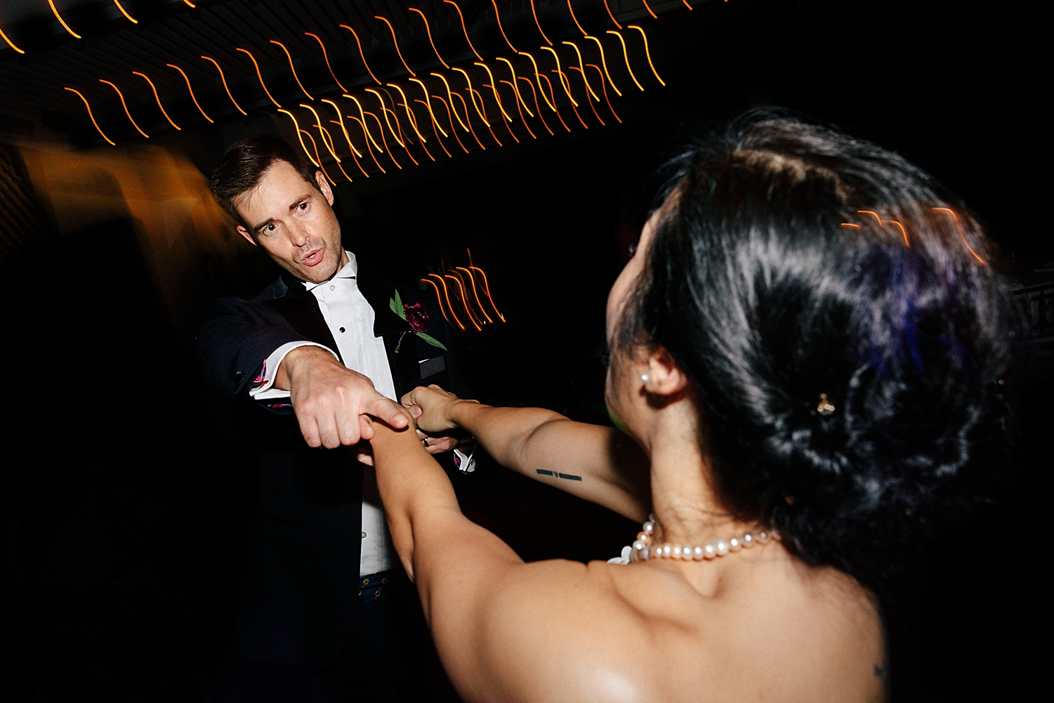 groom spinning bride on dance floor wedding reception