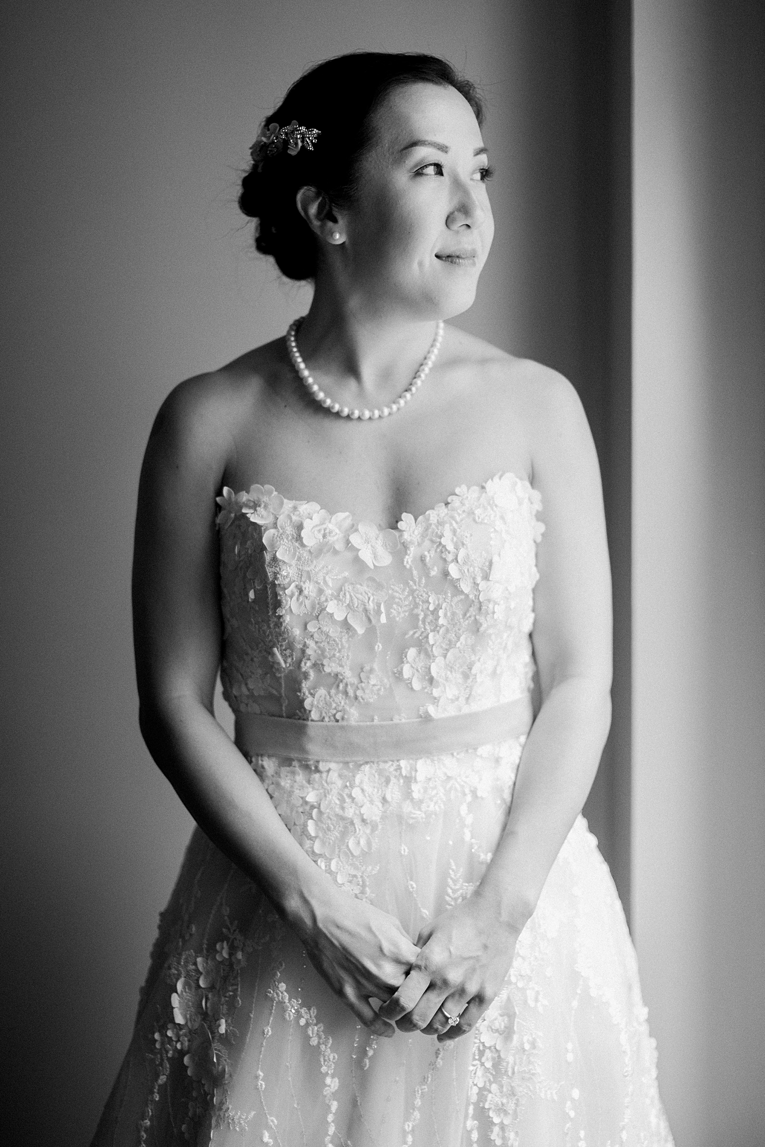 bride in strapless wedding dress pearl necklace