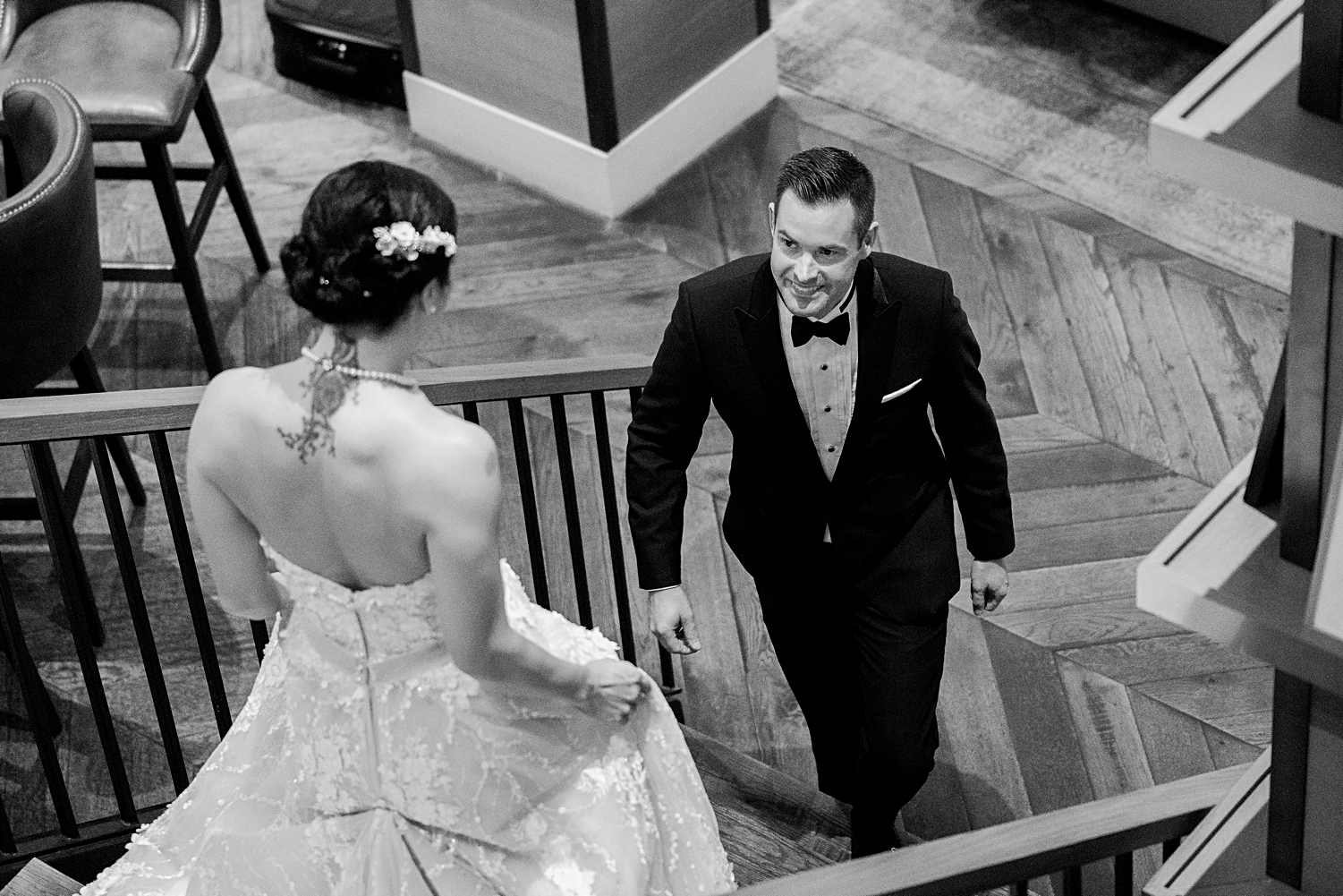 groom walking up stairs to bride in wedding dress