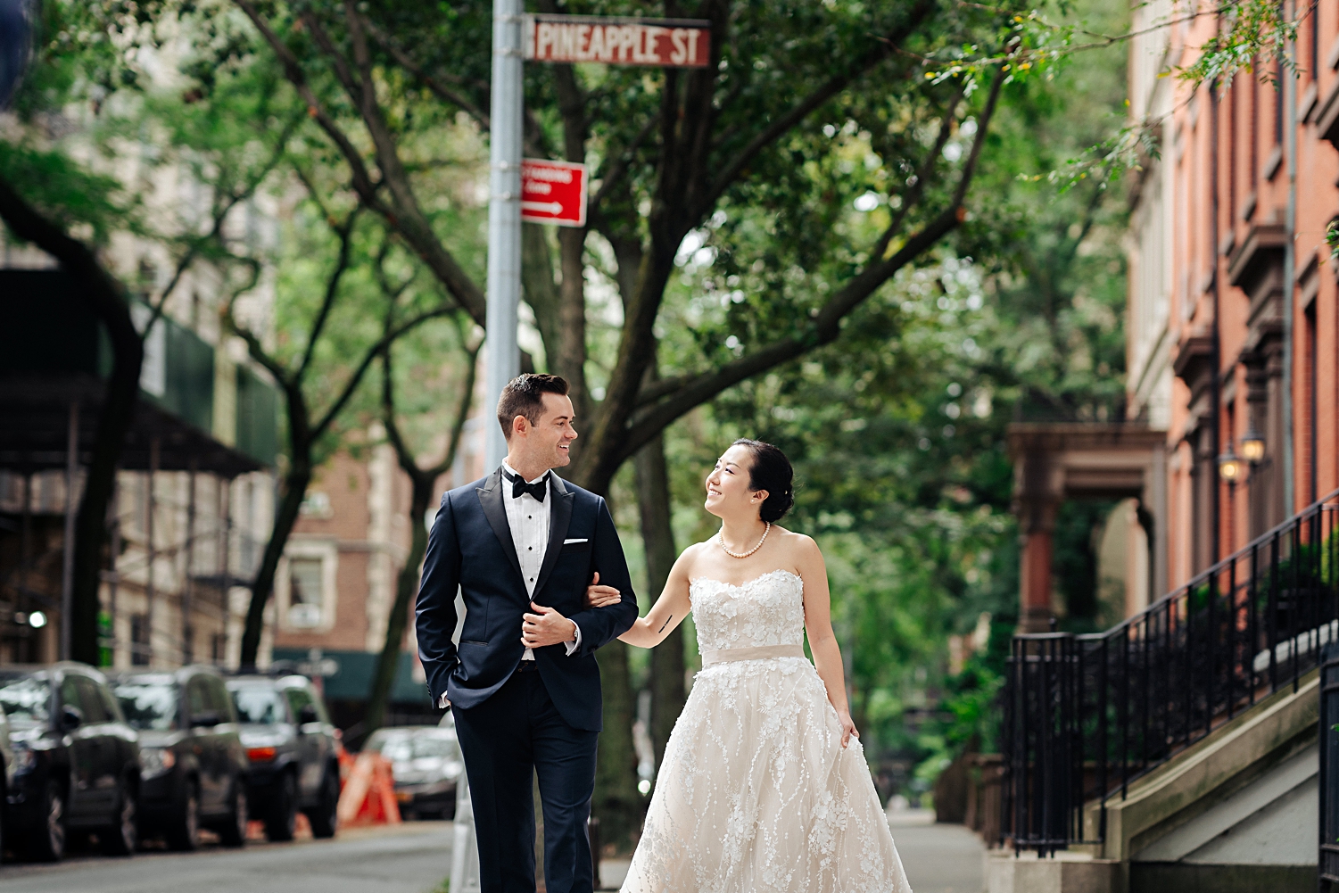 bride and groom walking arm in arm on street brooklyn new york city wedding