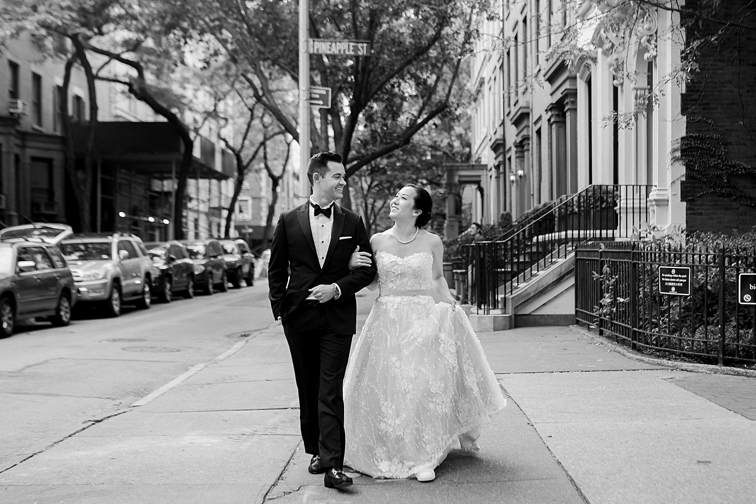 bride and groom walking on street brooklyn new york wedding in black and white