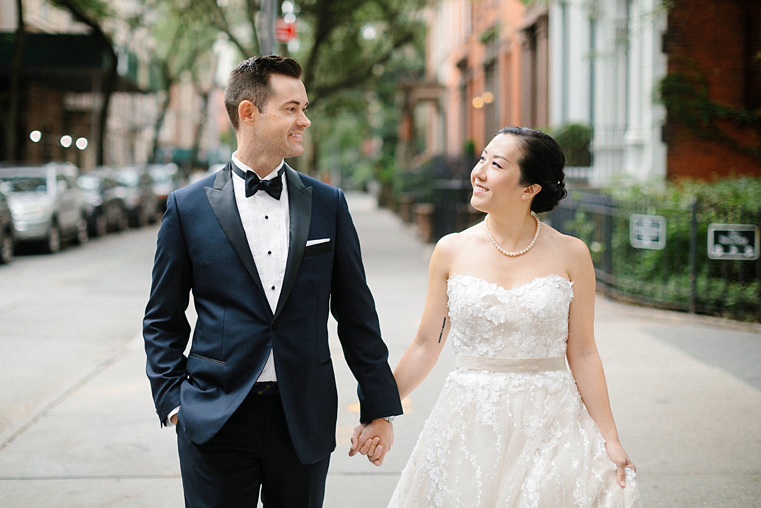 bride and groom holding hands on street brooklyn new york city wedding
