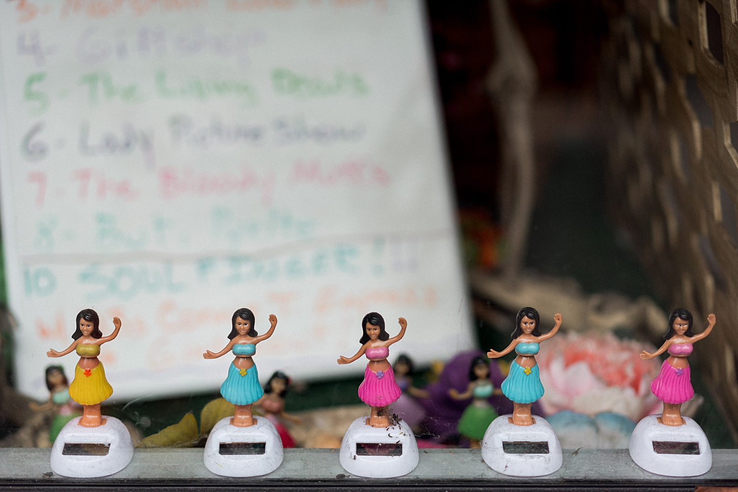 small hula girl figures in window display