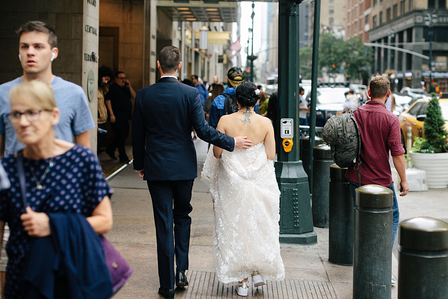 bride and groom walking on midtown manhattan sidewalk