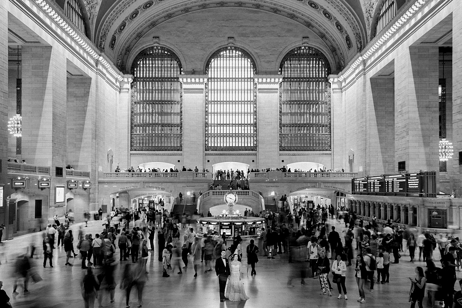bride and groom standing in grand central station new york city