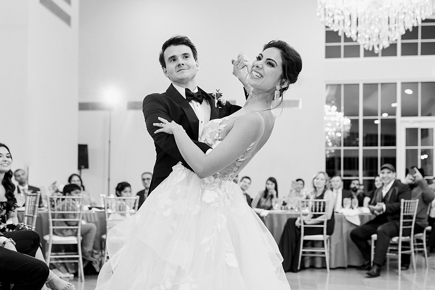 bride and groom dancing at wedding reception dipping black and white