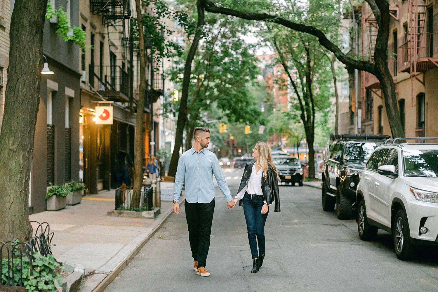 Couple walking down NYC street holding hands
