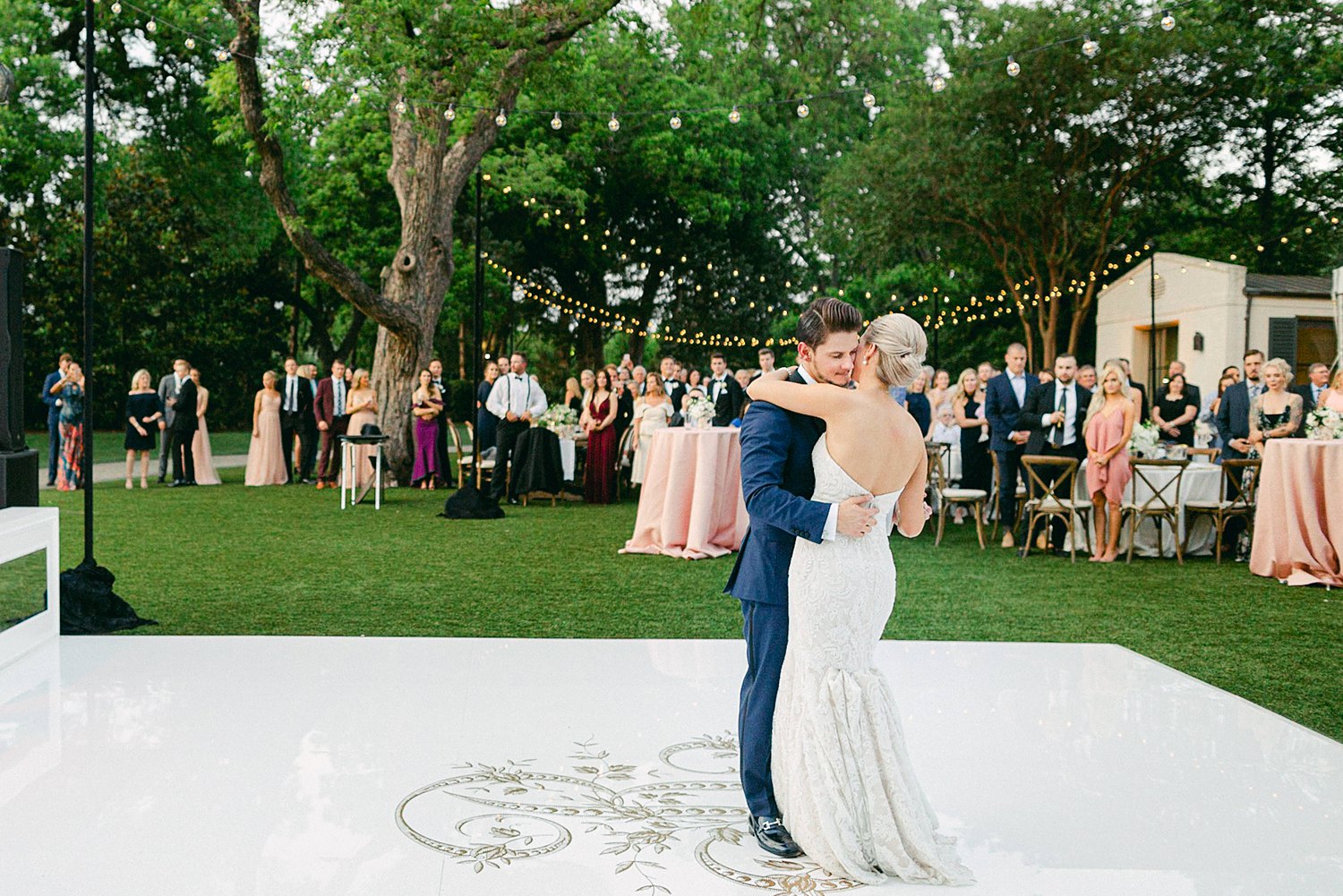 Bride and groom dancing on white outdoor dance floor Dallas Arboretum wedding garden reception