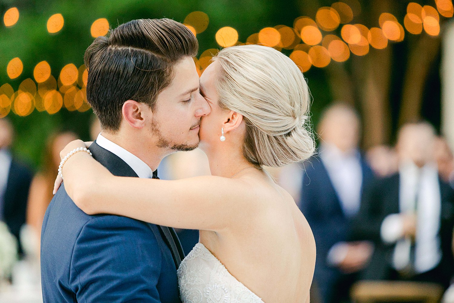 Bride and groom dancing cheek to cheek on white outdoor Arboretum wedding reception