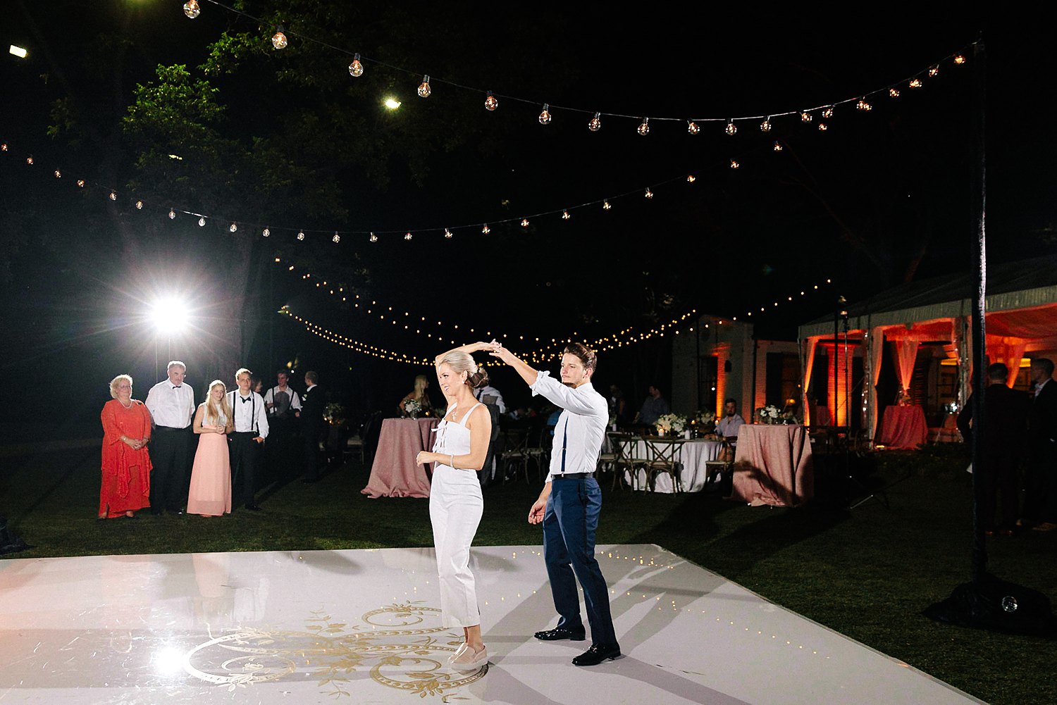 Bride and groom laughing and dancing at wedding reception outdoors dallas arboretum wedding white dance floor