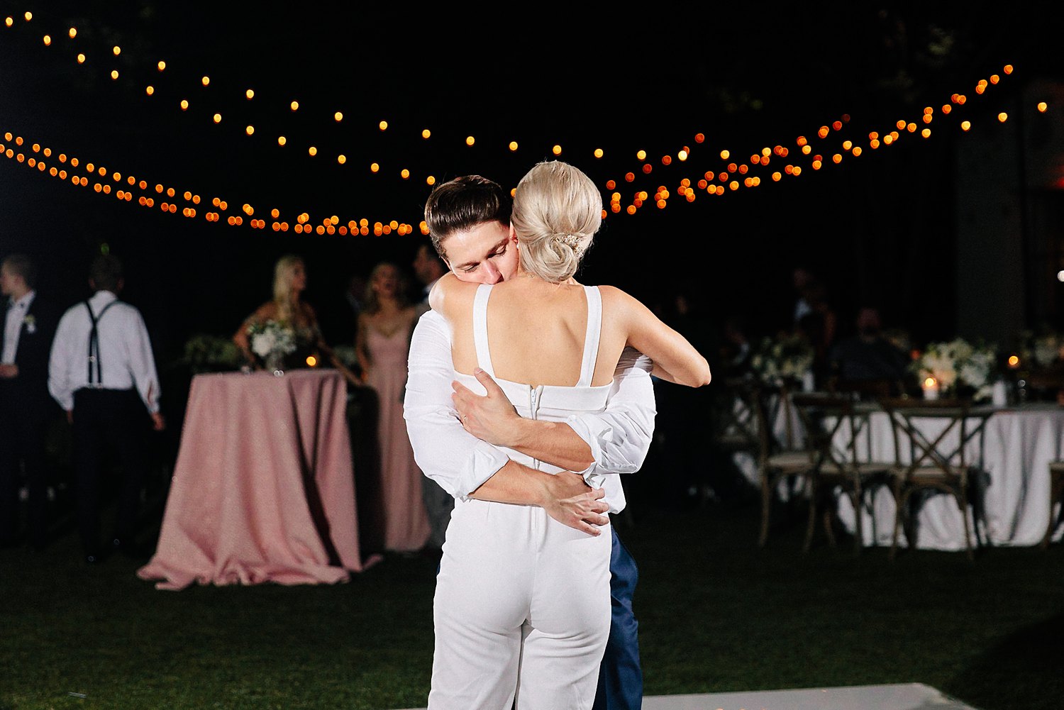 Bride and groom reception outdoors dallas arboretum wedding hugging