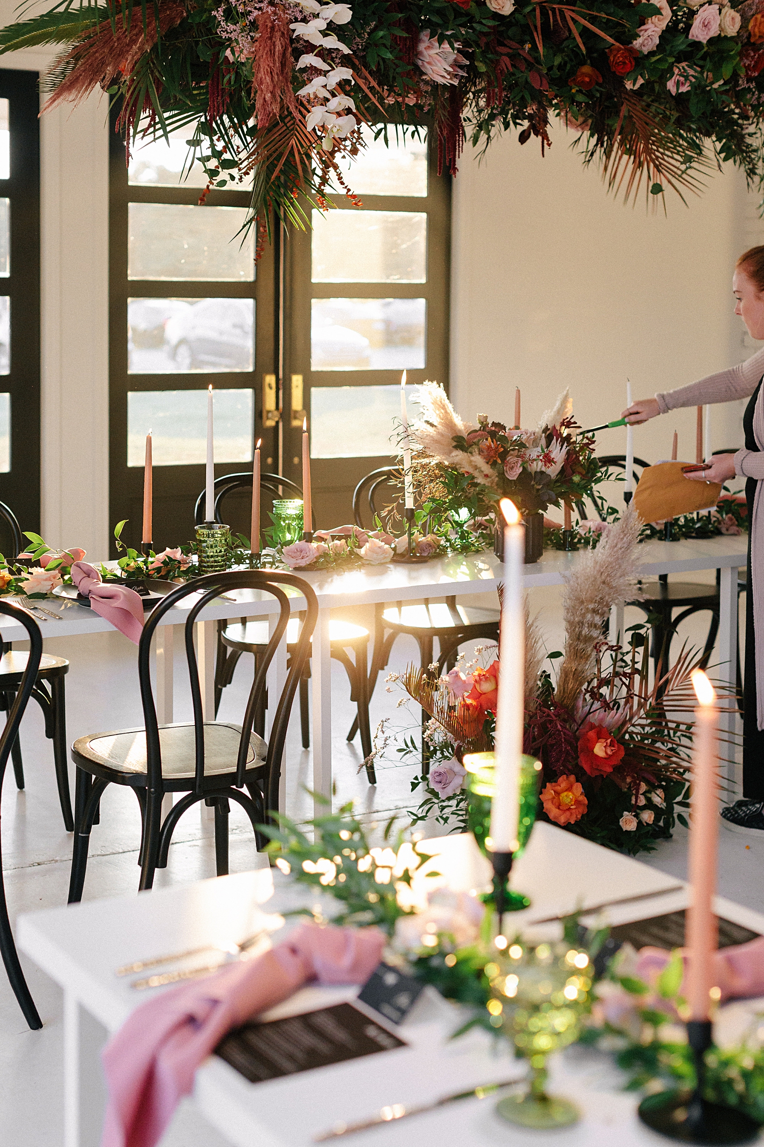 reception tables floral instillations black chairs white room candles Emerson Venue Wedding