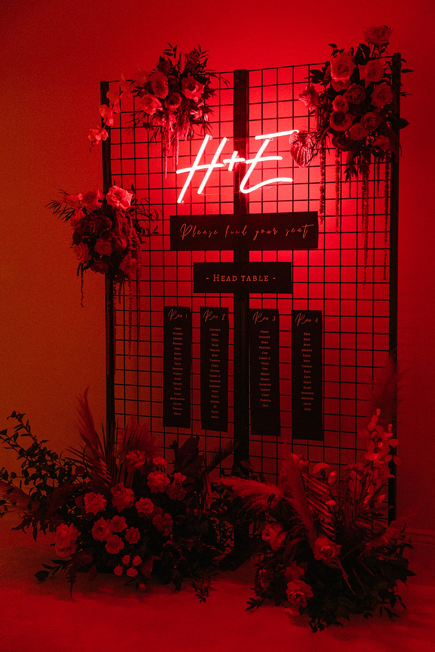 Red neon initials seating chart with floral instillation reception Emerson Venue Wedding