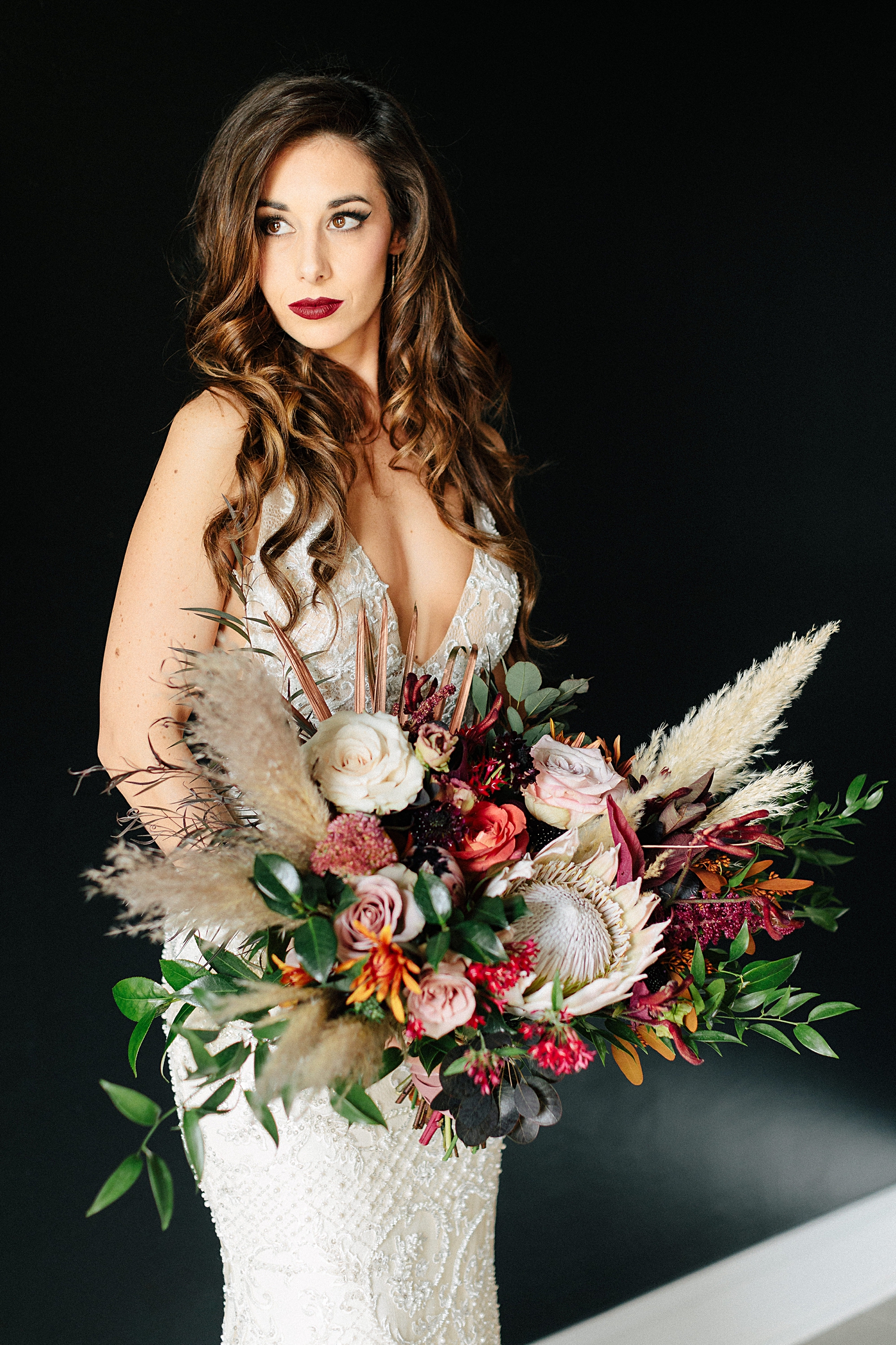 bride with large bouquet wedding black background