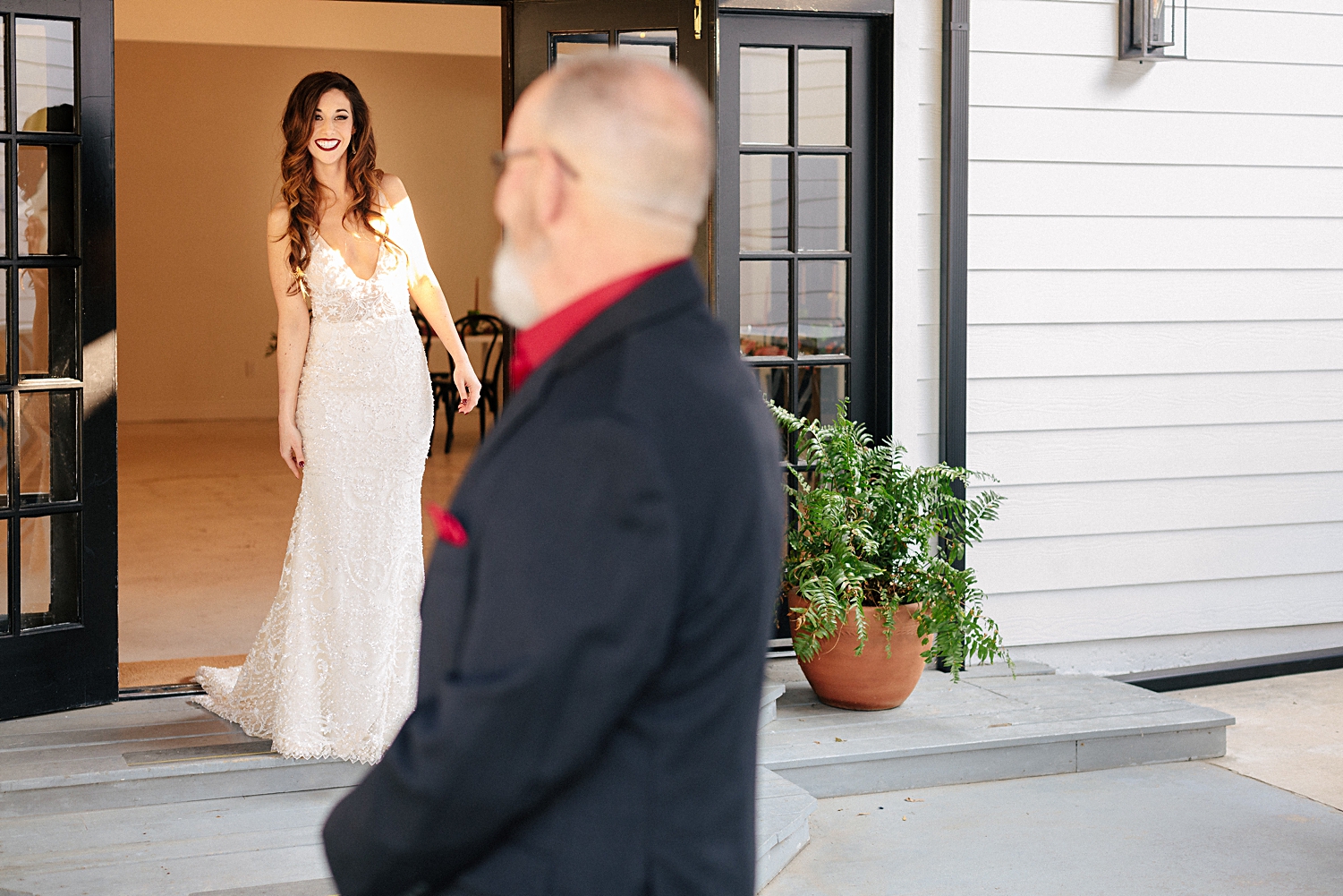 bride in wedding dress smiling first look with father Emerson Venue Wedding