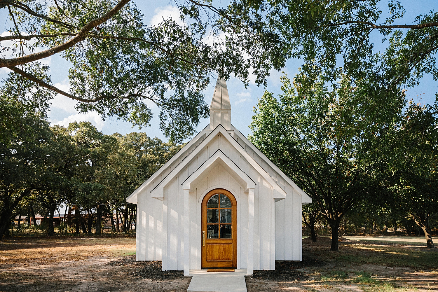 white chapel surrounded by trees Emerson Wedding Venue