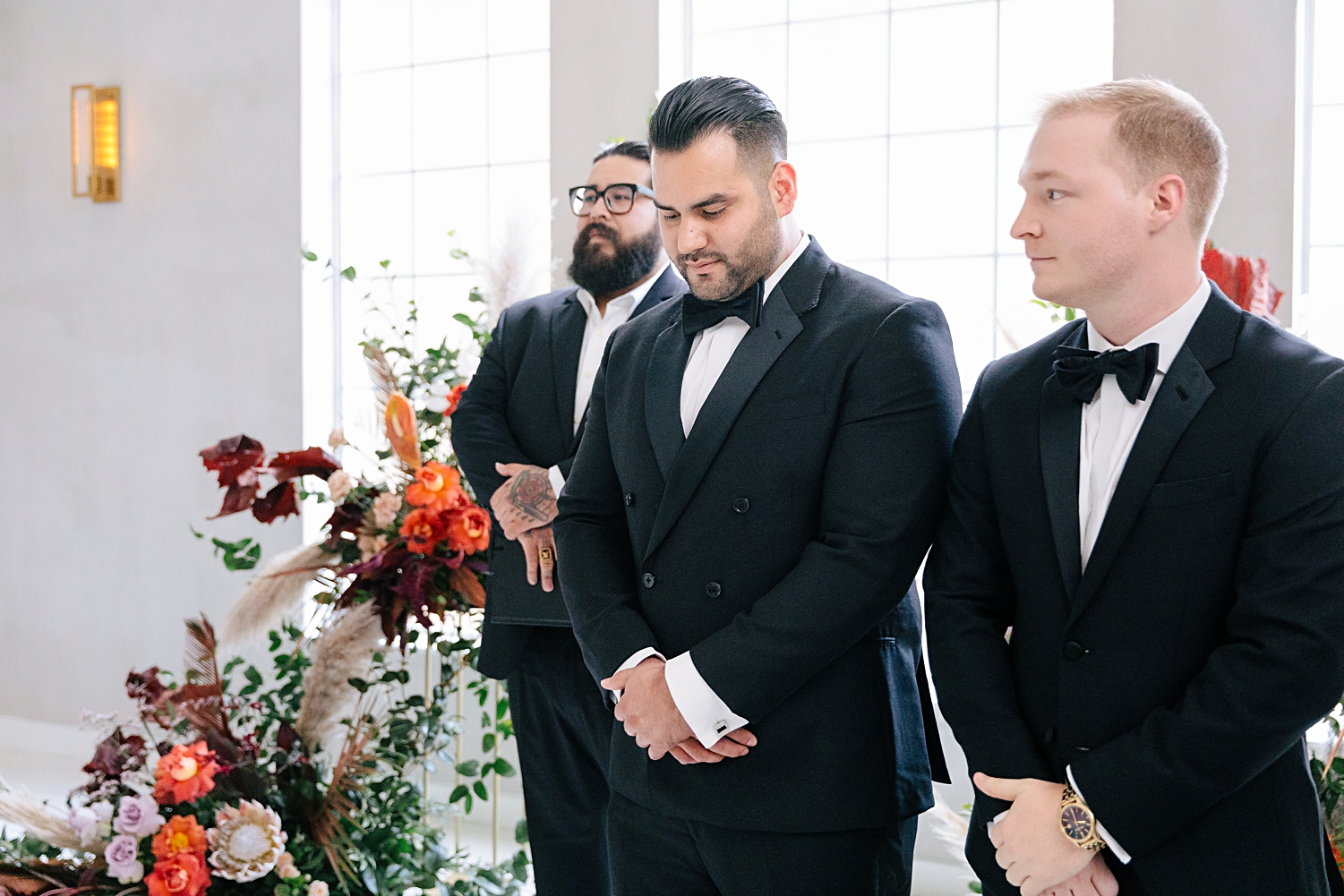 groom in tuxedo standing at altar white chapel wedding