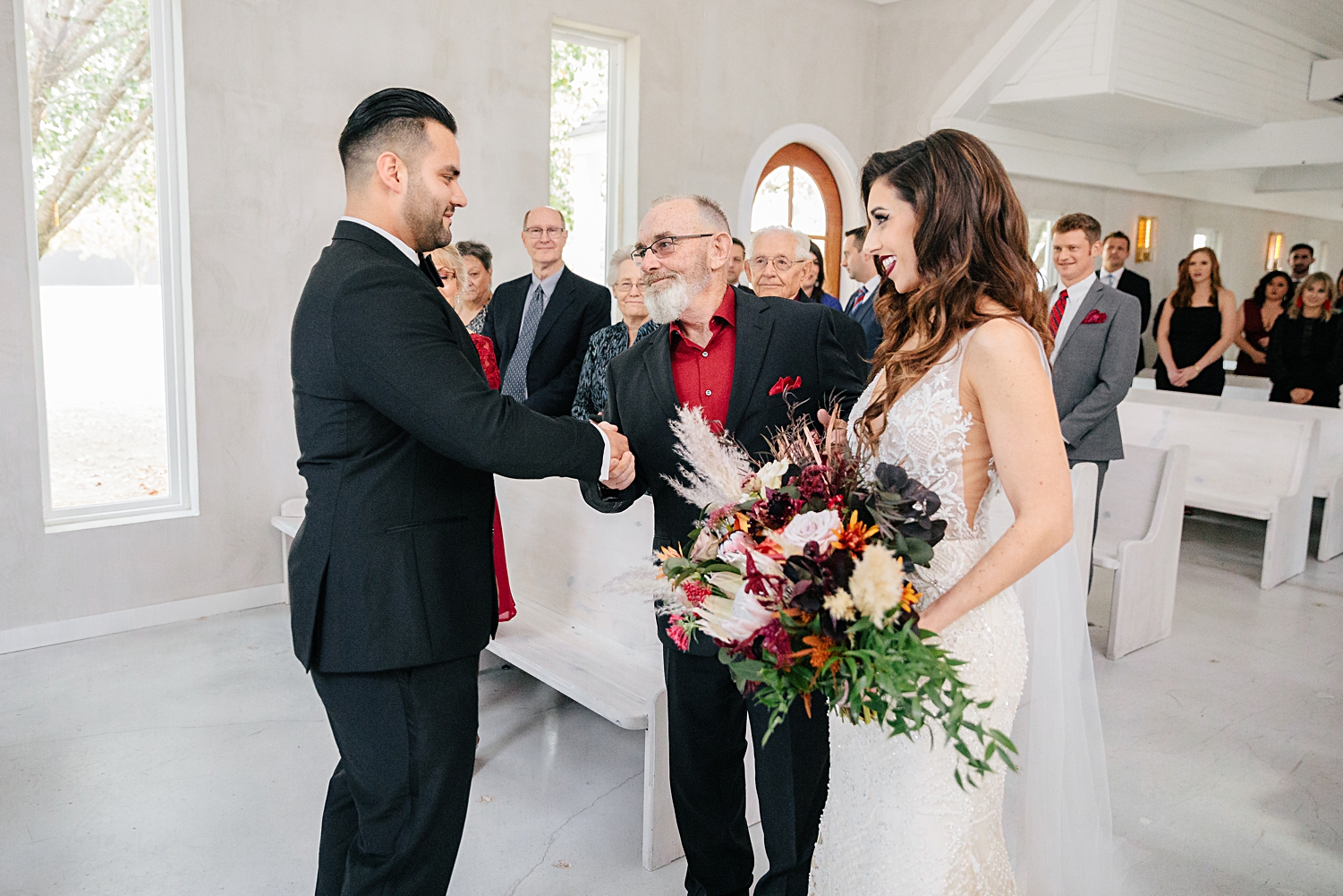 groom shaking hands with father of bride at altar white chapel Emerson wedding