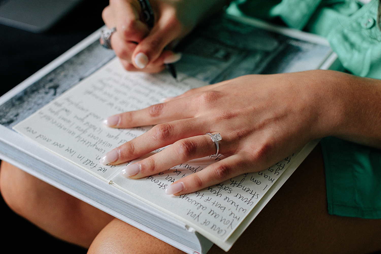 girl writing wedding vows in book