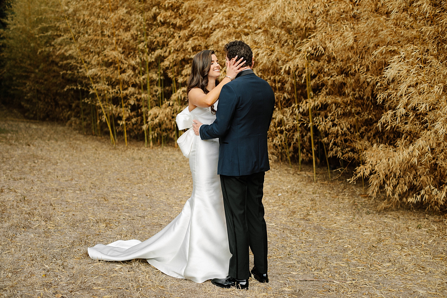 bride and groom seeing each other first time wedding look reaction in front of golden plants