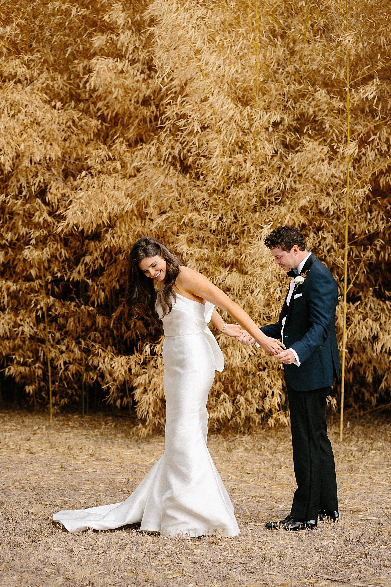 bride and groom seeing each other wedding first look reaction in front of golden plants Matties 