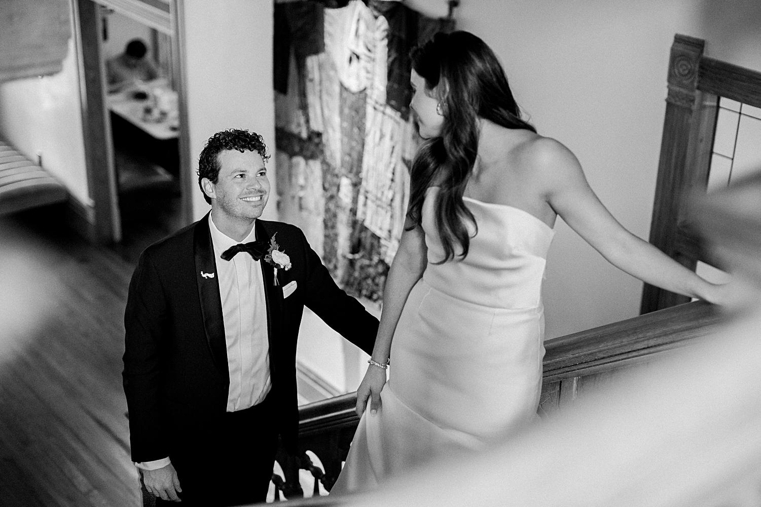 bride in strapless wedding dress with groom in tuxedo walking up stairs Mattie's Austin 