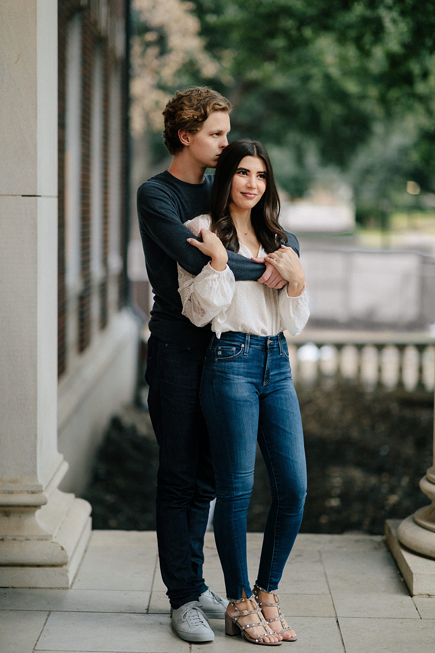 man embracing girl from behind during engagement session