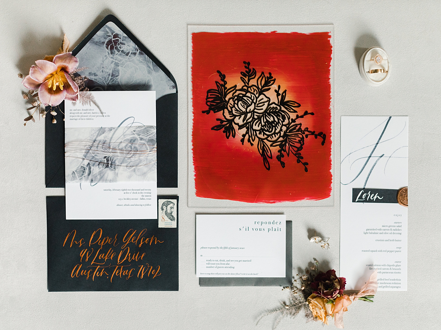 red, white, and black wedding invitation paper flat lay 