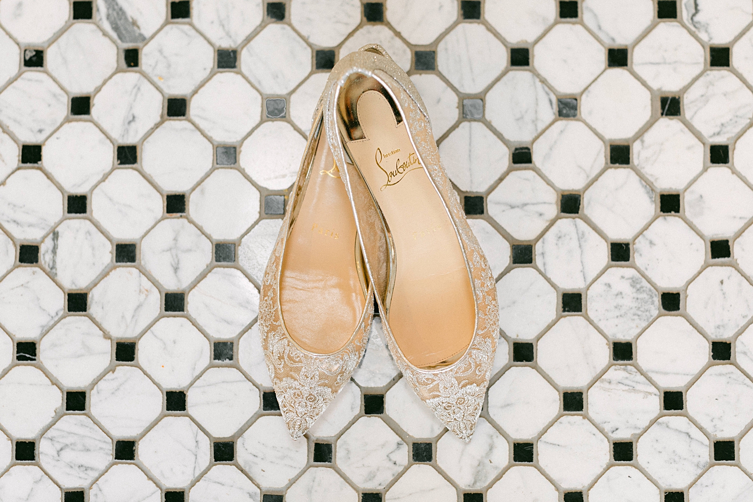 Louboutin flats bridal shoes on tile floor
