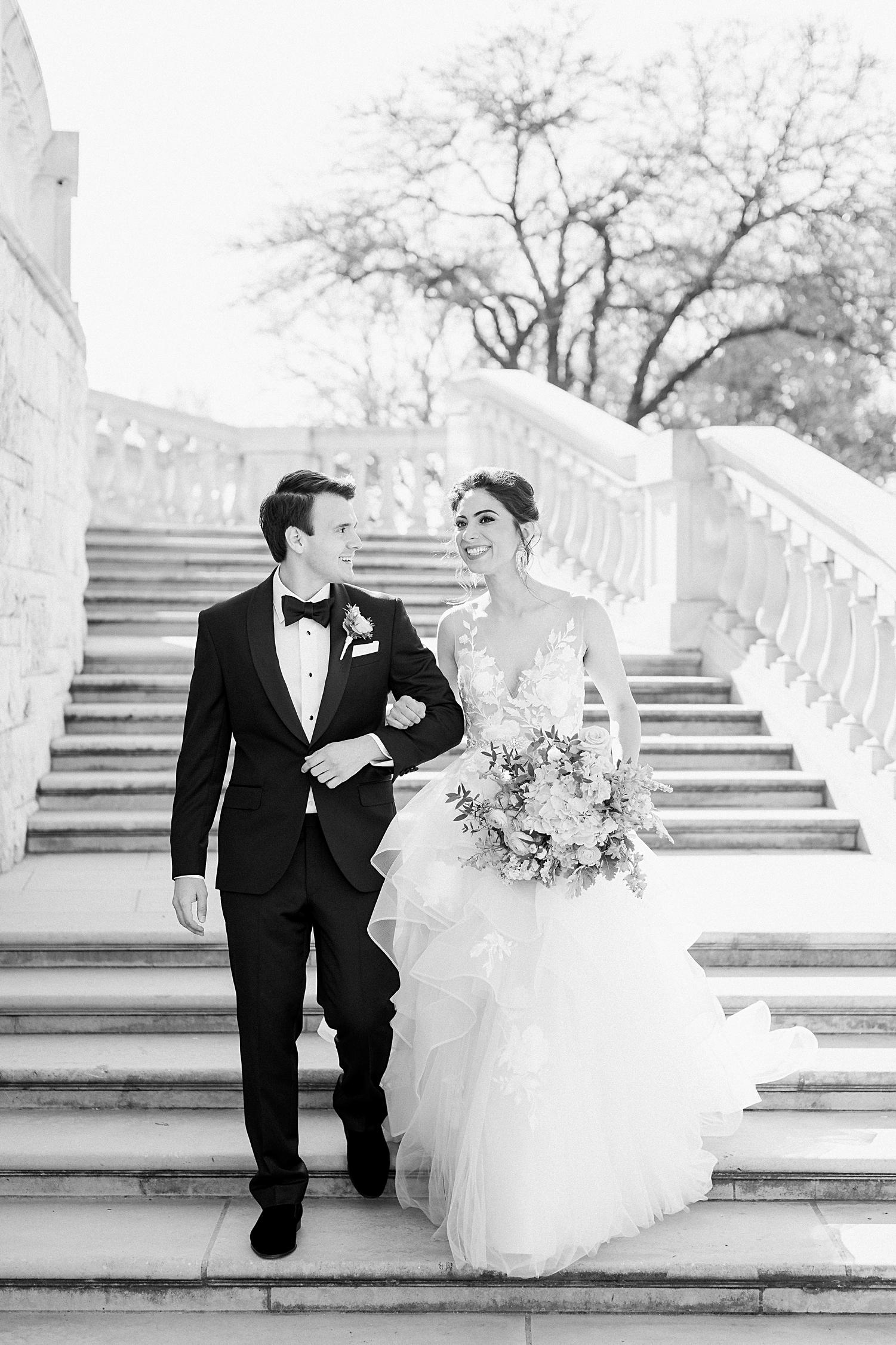 Bride and groom walking down outdoor staircase french estate wedding black and white