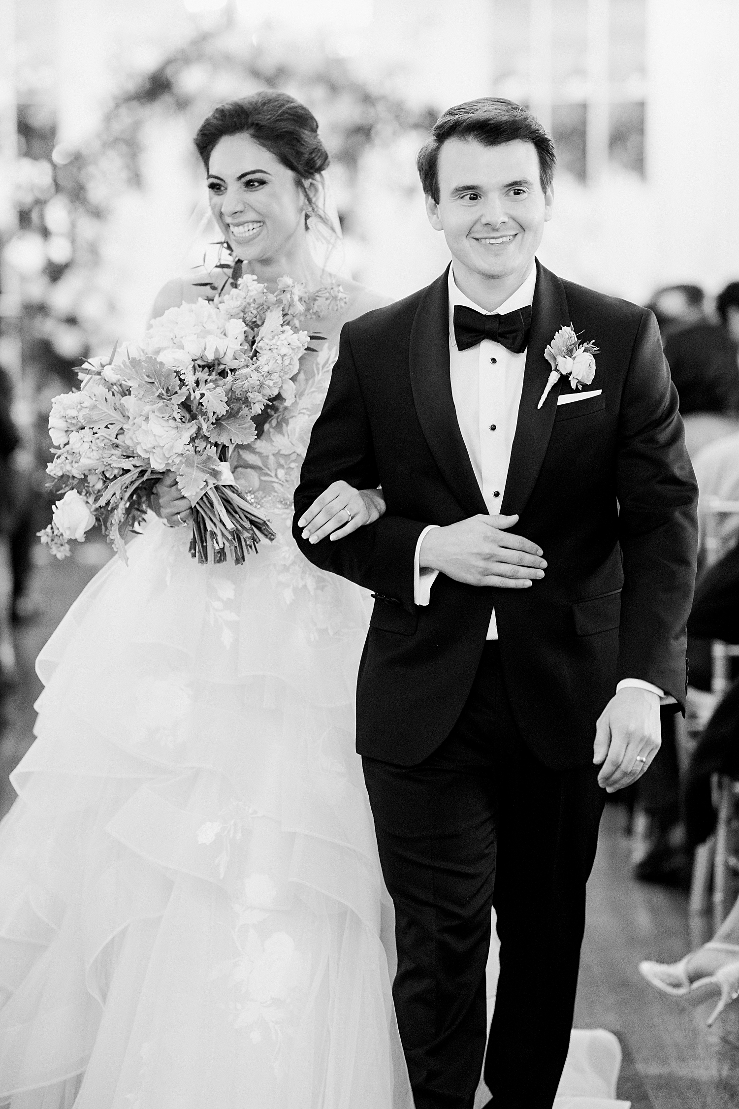 Indoor french estate wedding ceremony bride and groom walking out of ceremony black and white