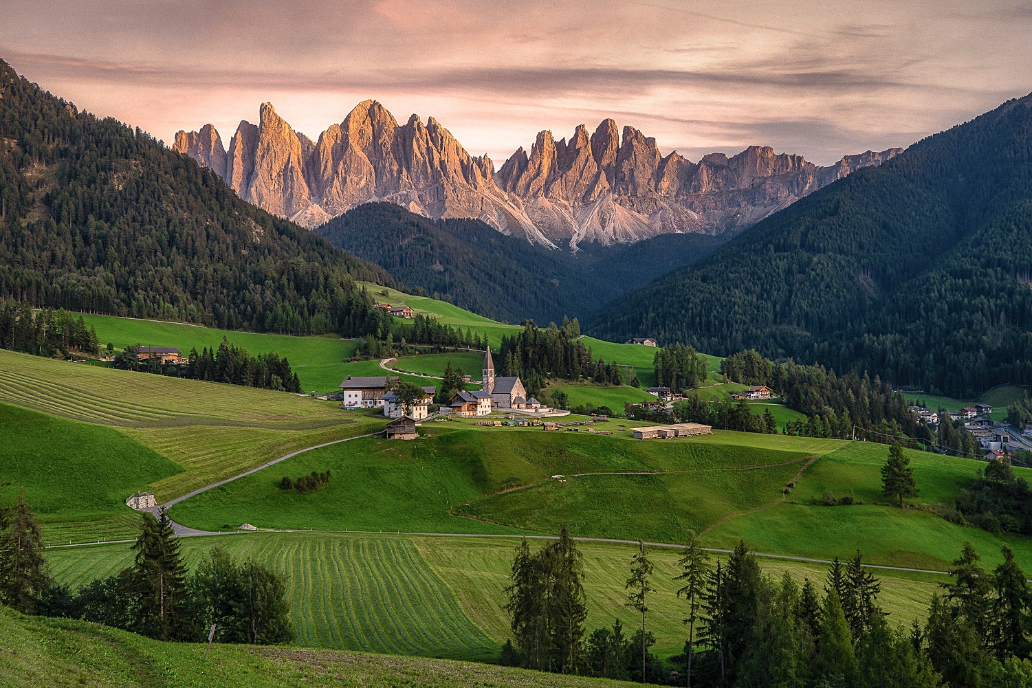 Dolomite Italy mountains rise above green village valley 