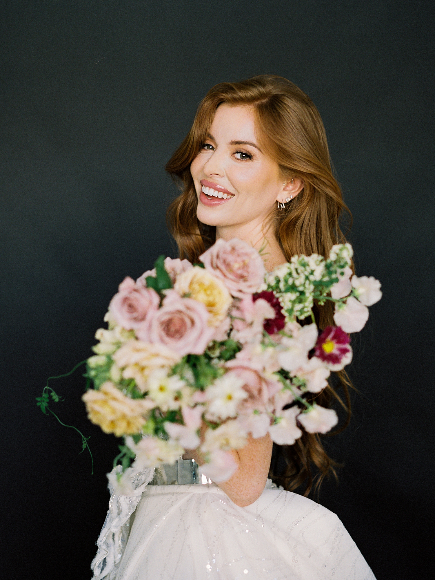 red headed bride holding colorful bridal bouquet