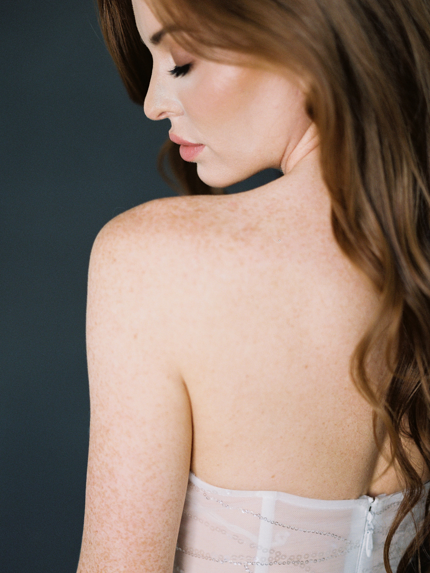 side profile of red headed girl looking over shoulder