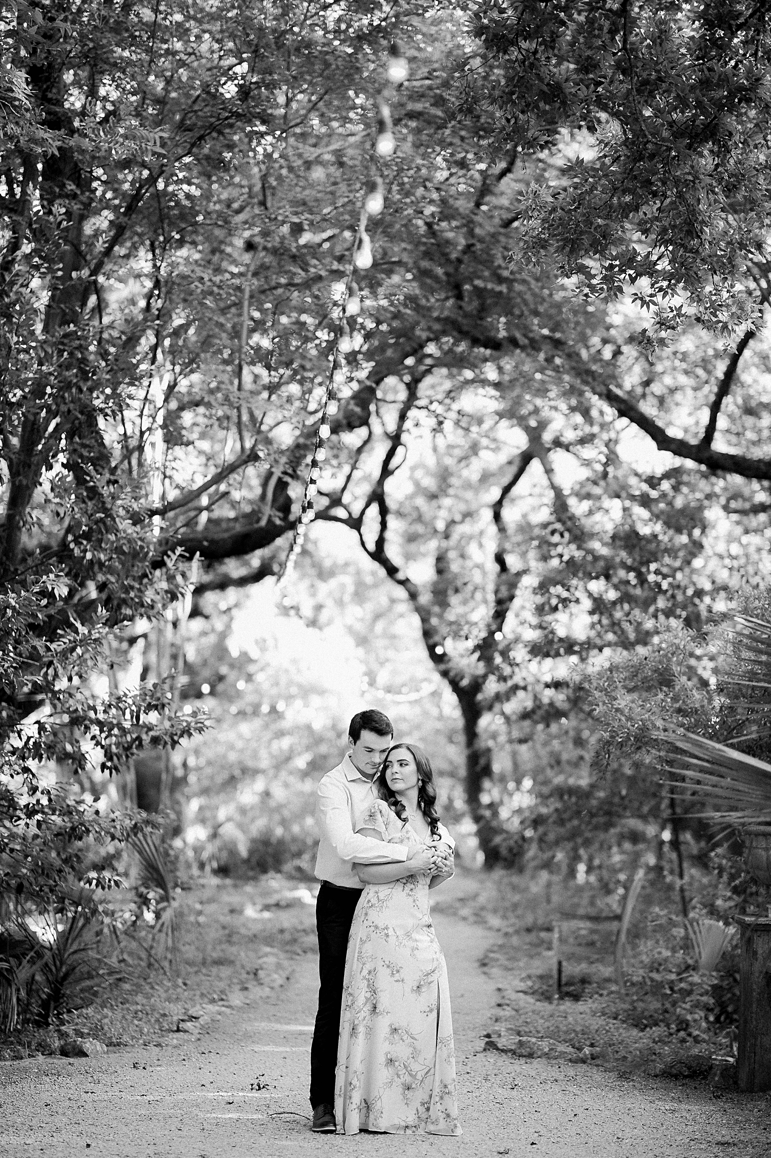 couple standing in forest black and white