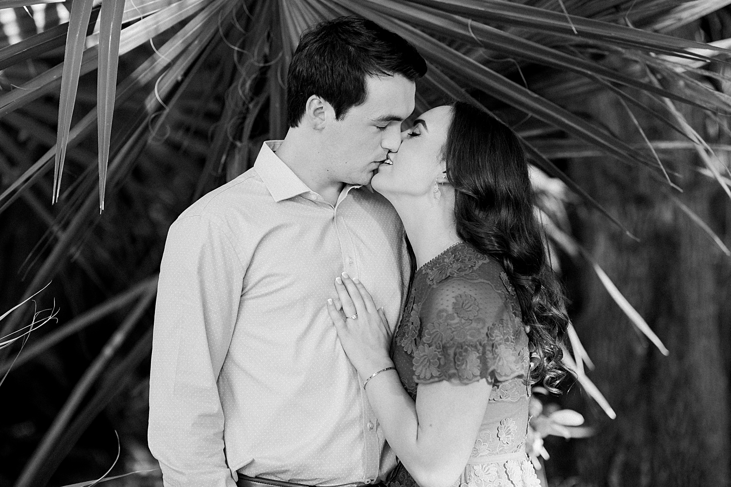 Man and woman in kissing in garden Austin engagement at Laguna Gloria